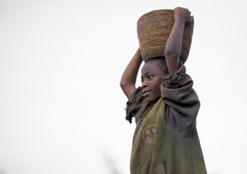 Rwandan child carrying stuff on his head, Northwest Province, Rehengeri, Rwanda