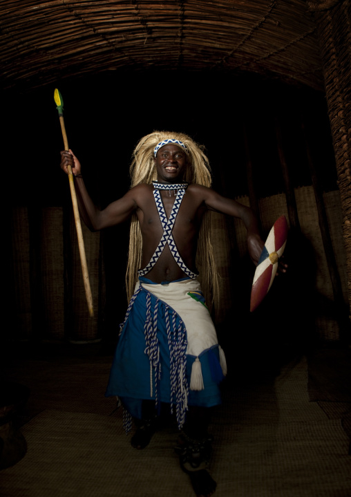 Traditional intore dancer with a shield during a folklore event in a village of former hunters, Lake Kivu, Ibwiwachu, Rwanda