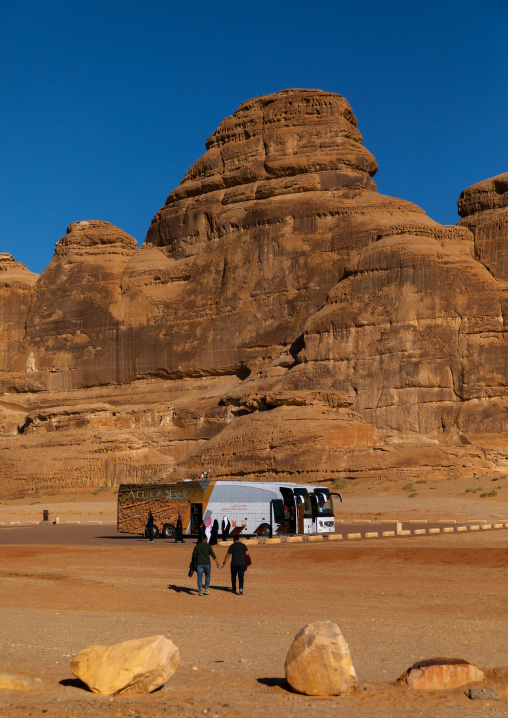 Tourists coming out of a bus during a visit in Madain Saleh archaeological site, Al Madinah Province, Alula, Saudi Arabia