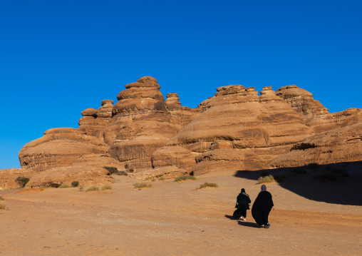 Saudi women in the rocky landscape of Madain Saleh, Al Madinah Province, Alula, Saudi Arabia