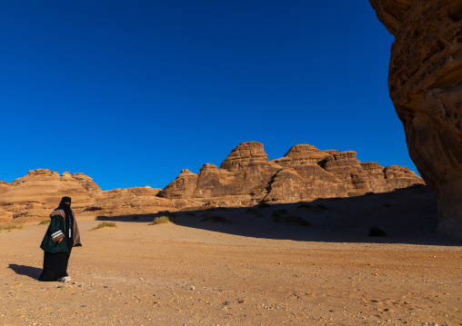 Saudi woman in the rocky landscape of Madain Saleh, Al Madinah Province, Alula, Saudi Arabia
