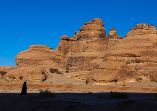 Woman silhouette in the rocky landscape of Madain Saleh, Al Madinah Province, Alula, Saudi Arabia