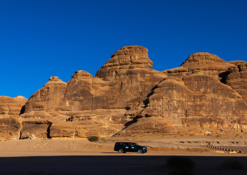 Tourist car in the rocky landscape of Madain Saleh, Al Madinah Province, Alula, Saudi Arabia