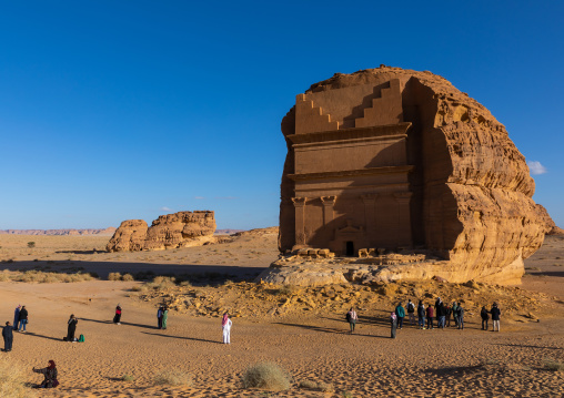 Tourists in front of qasr al-farid tomb of Lihyan son of Kuza in Madain Saleh, Al Madinah Province, Alula, Saudi Arabia