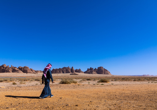 Saudi man walking in Madain Saleh, Al Madinah Province, Alula, Saudi Arabia