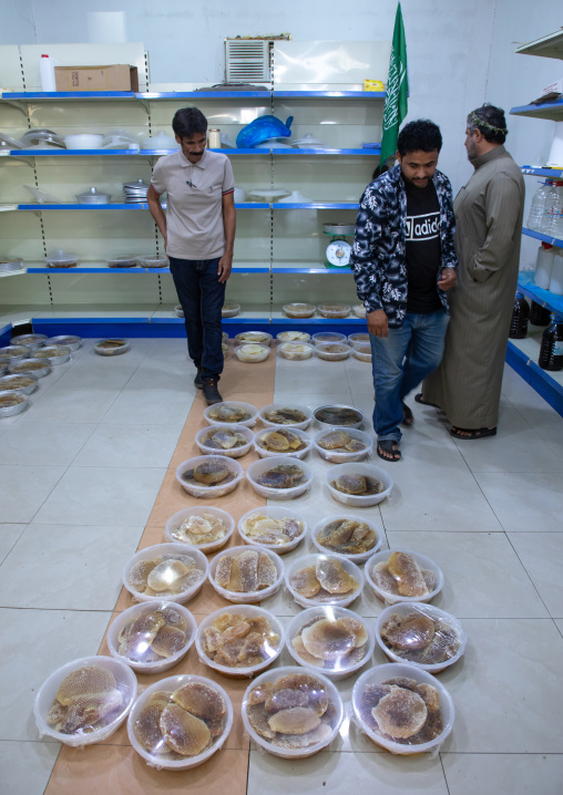 Saudi man selling honeycombs and honey in a shop, Asir province, Rijal Alma, Saudi Arabia
