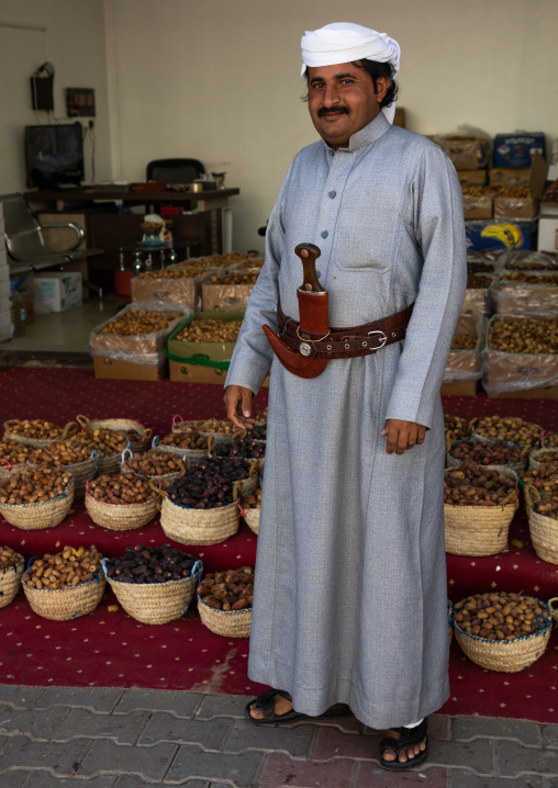 Saudi man in traditional clothing selling sweet dates, Najran Province, Najran, Saudi Arabia