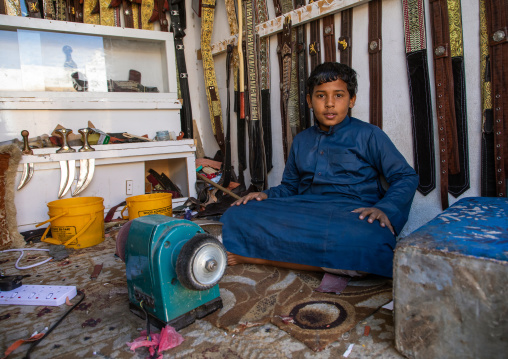 Yemeni refugee boy making jambiyas in a shop, Najran Province, Najran, Saudi Arabia