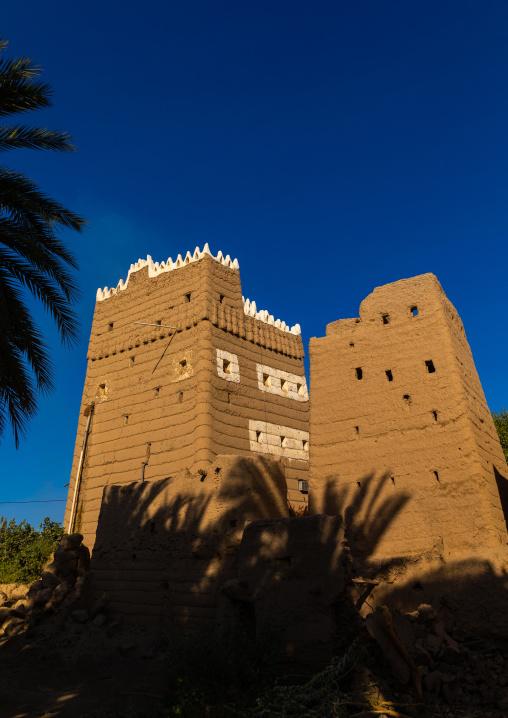 Traditional old multi-storey mud house in the middle of plam trees, Najran Province, Najran, Saudi Arabia