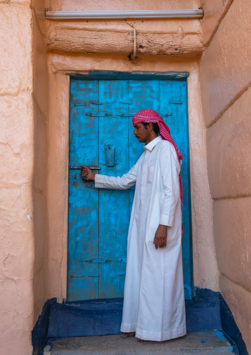 Saudi man at the entrance of his traditional house, Najran Province, Najran, Saudi Arabia