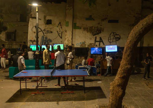 Somali refugees children playing video games in the street in al-Balad quater, Mecca province, Jeddah, Saudi Arabia