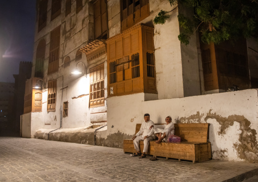 Two men resting on a bench in al-Balad quarter, Mecca province, Jeddah, Saudi Arabia