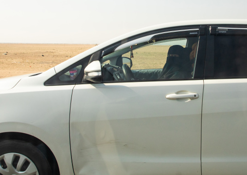 Saudi woman driving alone in a car on the highway, Mecca province, Jeddah, Saudi Arabia
