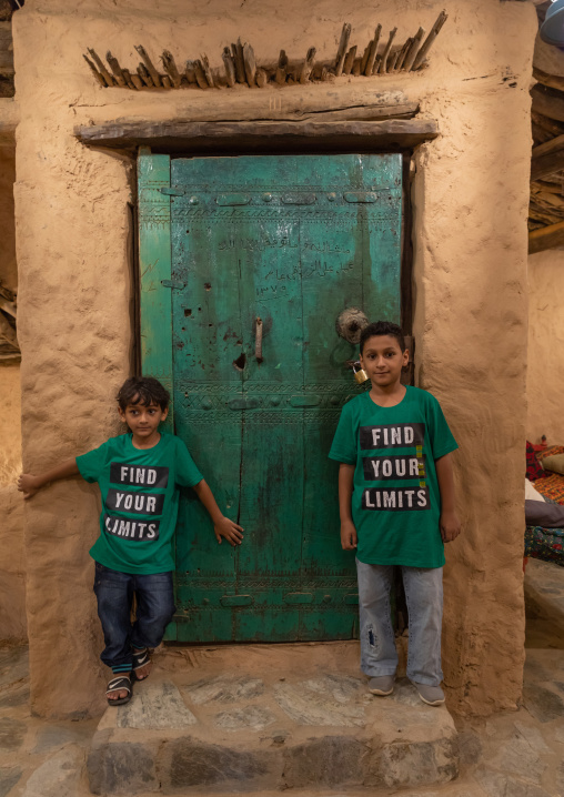 Saudi boys standing in front of al Baitul Jabali house, Jizan Province, Jizan, Saudi Arabia