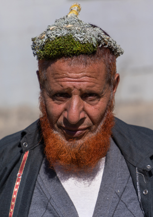 Portrait of a flower man with a red beard wearing a floral crown on the head, Jizan Province, Addayer, Saudi Arabia