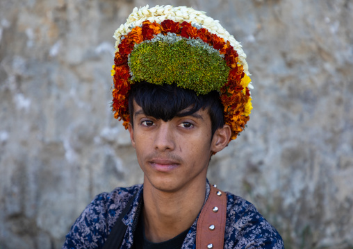 Portrait of a flower young man wearing a floral crown on the head, Jizan Province, Addayer, Saudi Arabia
