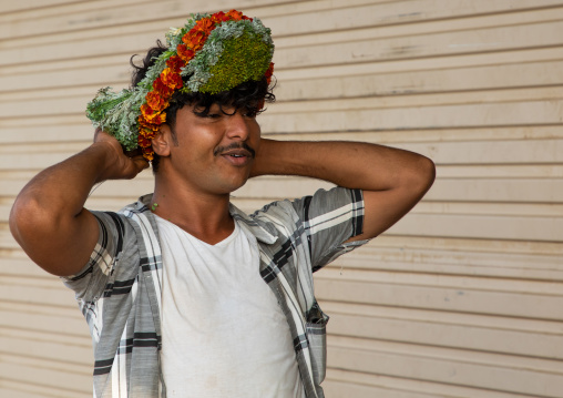 Portrait of a flower man putting a floral crown on the head, Jizan Province, Mahalah, Saudi Arabia
