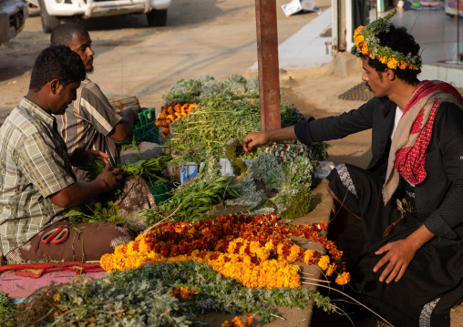 A flower vendor preparing and selling floral garlands and crowns on a market, Jizan Province, Mahalah, Saudi Arabia