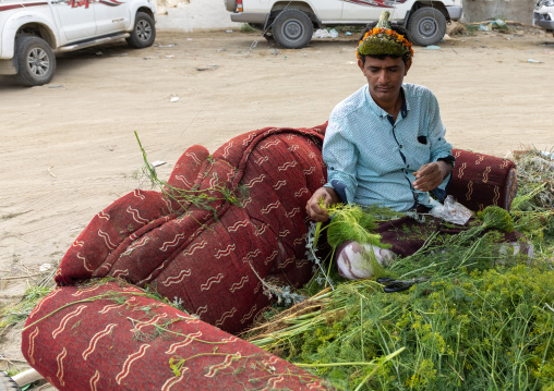A flower vendor preparing floral garlands and crowns on a market, Jizan Province, Addayer, Saudi Arabia