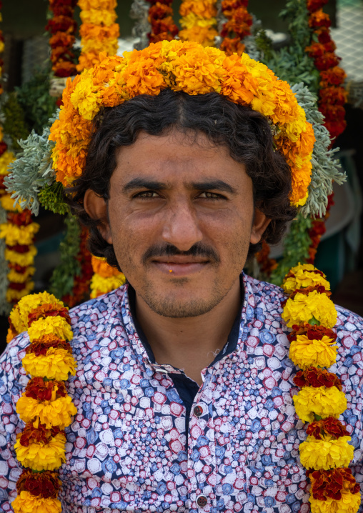 A flower vendor with floral garlands and crowns on a market, Jizan Province, Addayer, Saudi Arabia