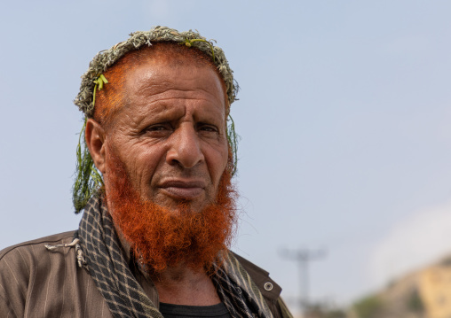 Portrait of a flower man with a red beard wearing a floral crown on the head, Jizan Province, Addayer, Saudi Arabia