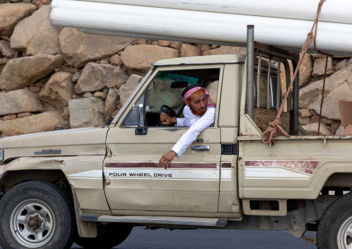 Saudi man driving his toyota car transporting pipes, Jizan Province, Addayer, Saudi Arabia