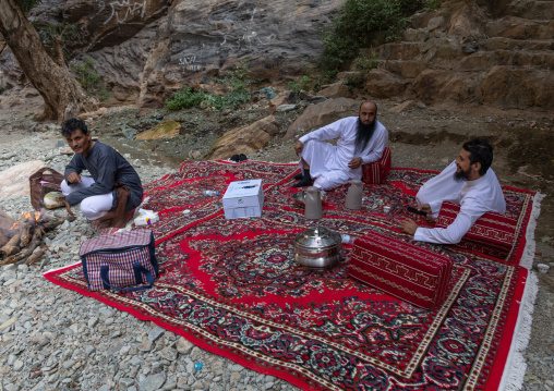Saudi men having picnic in wadi lajab, Jizan Province, Jebel Qahar, Saudi Arabia
