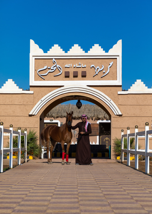 saudi man with his Arabian horse in Alhazm stud, Najran Province, Khubash, Saudi Arabia