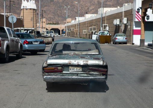 Rear view of a damaged car on a road, Najran Province, Najran, Saudi Arabia