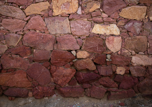 Red stones of a wall of a house, Asir province, Sarat Abidah, Saudi Arabia