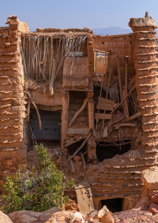 Red stone and mud collpased house in a village, Asir province, Sarat Abidah, Saudi Arabia