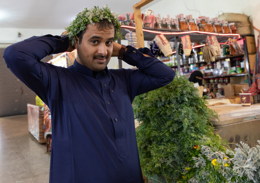 Portrait of a flower man wearing a floral crown on the head, Asir province, Muhayil, Saudi Arabia