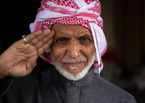 Portrait of saudi man with a keffieh saluting, Asir province, Tanomah, Saudi Arabia