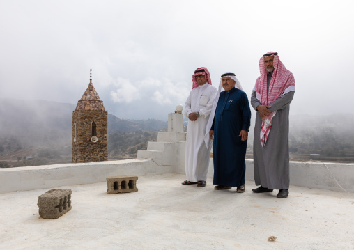 Saudi men in front of a mosque made of stones, Asir province, Tanomah, Saudi Arabia