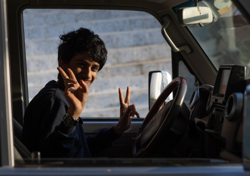 Teenage boy driving a car, Jizan Province, Addayer, Saudi Arabia