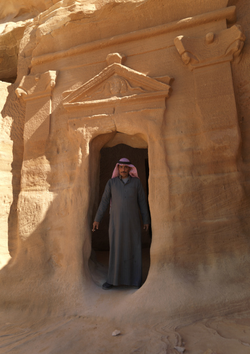 Saudi tourist in front of a Nabataean tomb in al-Hijr archaeological site in Madain Saleh, Al Madinah Province, Alula, Saudi Arabia