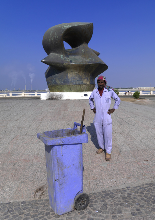Modern art on the corniche and a man cleaning the place, Mecca province, Jeddah, Saudi Arabia