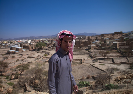 Portrait of a saudi man in front of an old village, Asir province, Ahad Rufaidah, Saudi Arabia