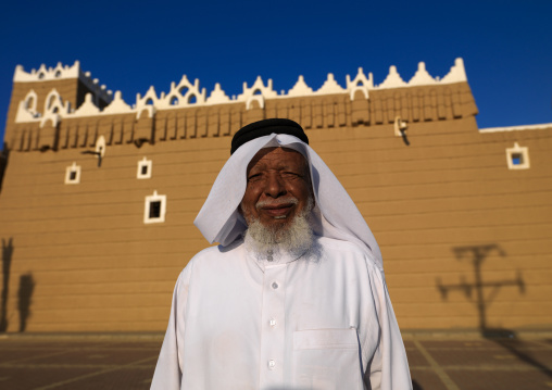 Old saudi man in front of the old fort, Najran Province, Najran, Saudi Arabia