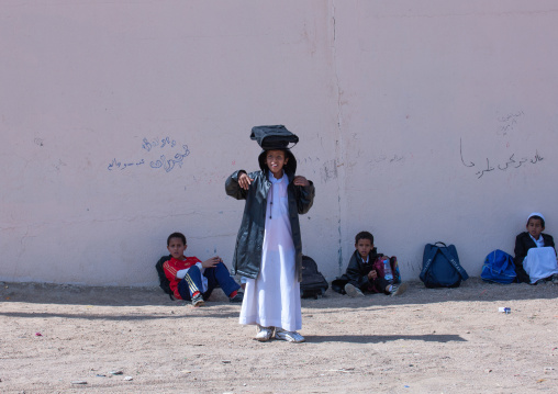 Saudi children resting in the street after school, Najran Province, Najran, Saudi Arabia