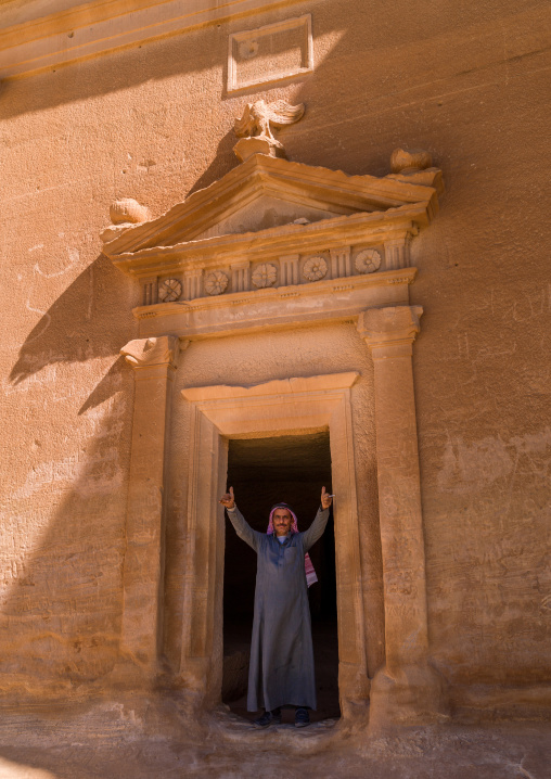 Saudi tourist in a nabataean tomb in madain saleh archaeologic site, Al Madinah Province, Al-Ula, Saudi Arabia