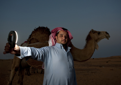 Portrait of a saudi manwith a camel, Al-Jawf Province, Sakaka, Saudi Arabia