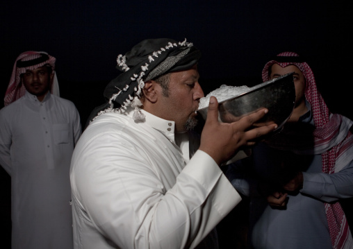 Saudi man drinking camel milk, Al-Jawf Province, Sakaka, Saudi Arabia