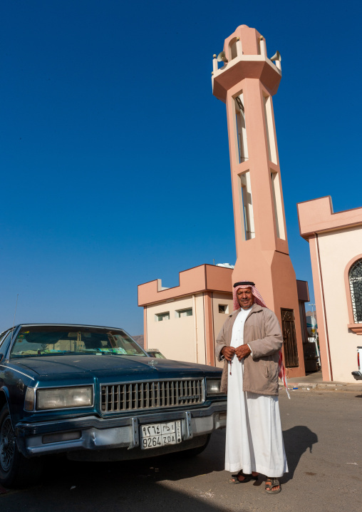 Saudi man and his car in front of a mosque, Najran Province, Najran, Saudi Arabia