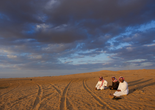 Saudi men resting in the desert, Al-Jawf Province, Al-Nefud, Saudi Arabia