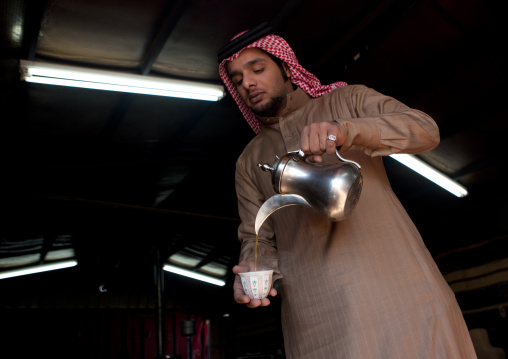 Portrait of a saudi man serving coffee, Al-Jawf Province, Sakaka, Saudi Arabia