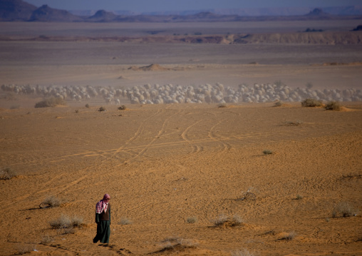 Saudi man walking in the desert, Al Madinah Province, Alula, Saudi Arabia