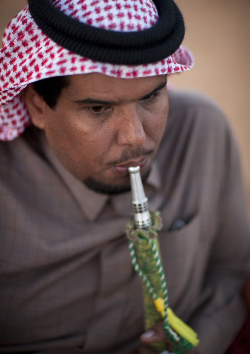 Portrait of a saudi man wearing a keffiyeh and smoking shisha, Al-Jawf Province, Sakaka, Saudi Arabia
