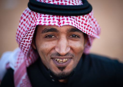 Portrait of a smiling saudi man wearing a kaffiyeh, Al-Jawf Province, Sakaka, Saudi Arabia