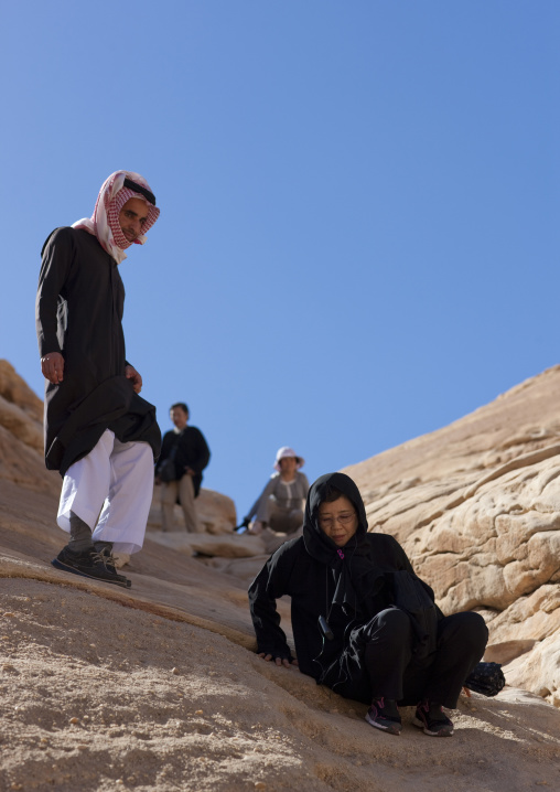 Tourist in al-Hijr archaeological site in Madain Saleh, Al Madinah Province, Alula, Saudi Arabia